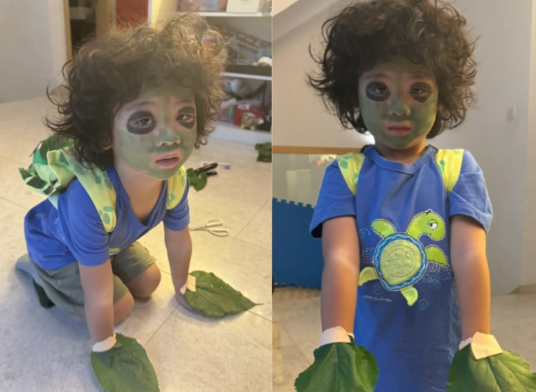 蔡少芬陪4岁的儿子张乐儿参与学校活动，亲手帮儿子化妆、用树叶和旧布，将他打扮成一只可爱的小海龟(图1)